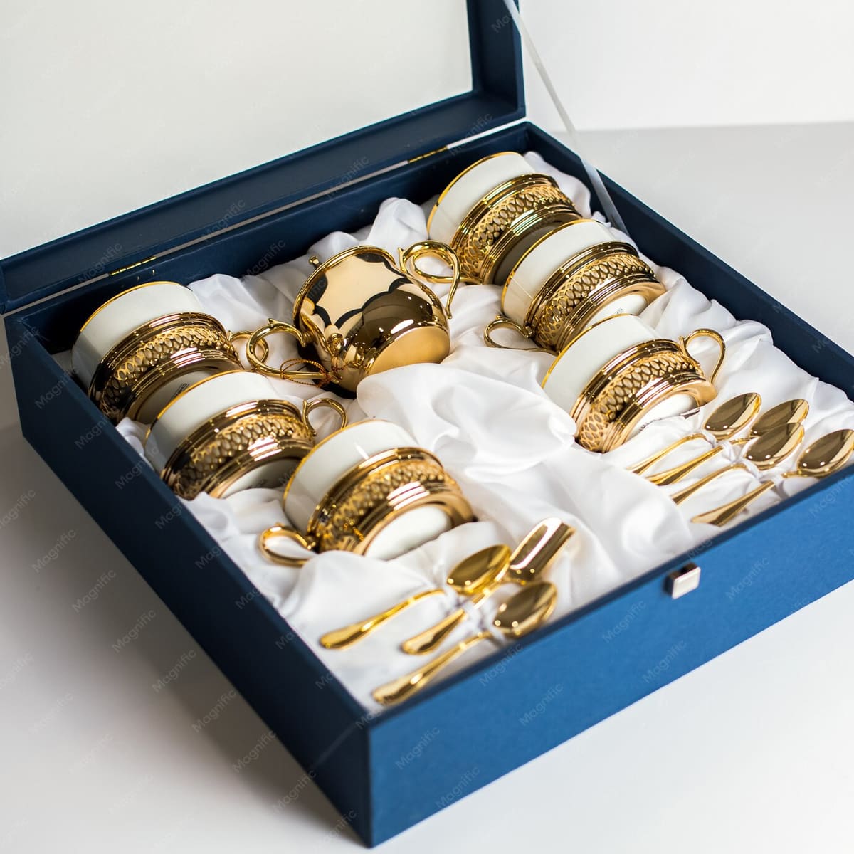 White and gold cutlery with matching glasses and cups in a presentation box